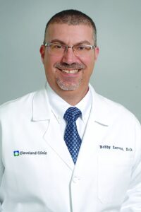 Dr. Xaralambos “Bobby” Zervos in a Cleveland Clinic white coat