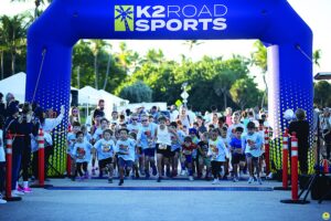 Children racing from the start arch at the Zoe Loren 5K kids dash