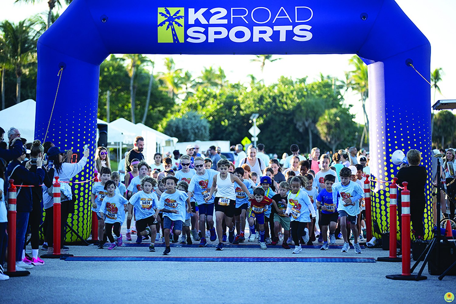 Children racing from the start arch at the Zoe Loren 5K kids dash