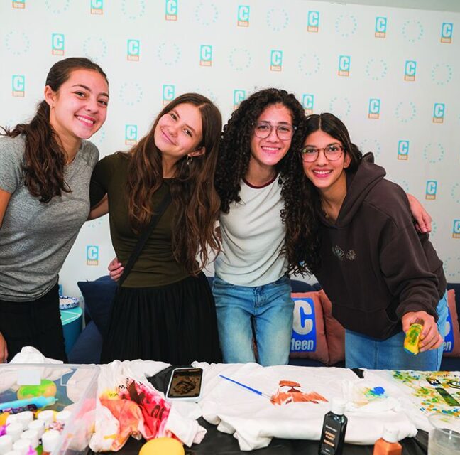 Hebrew School teen helpers at a craft table during the Open House