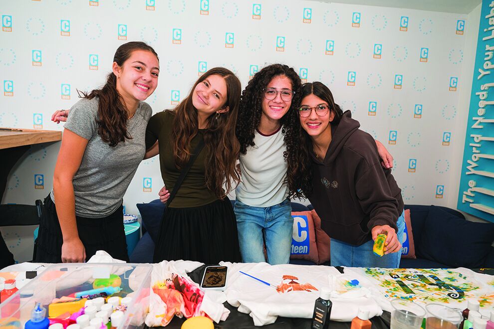 Hebrew School teen helpers at a craft table during the Open House